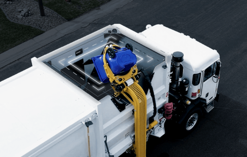 AI material contamination detection system on a McNeilus garbage truck identifies waste entering the hopper.