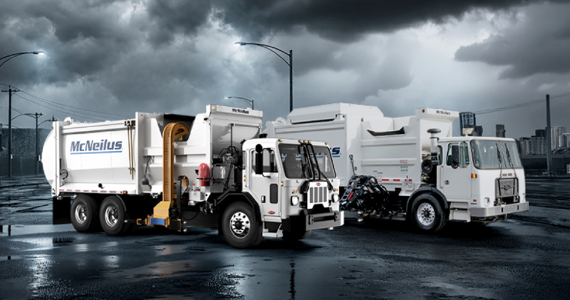 Two McNeilus refuse and recycling trucks equipped with material contamination detection technology.