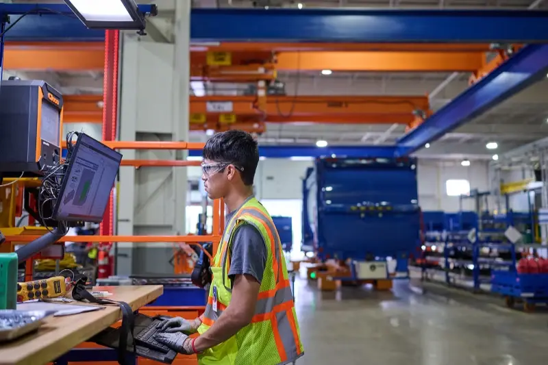 A technician uses a digital workstation on the McNeilus advanced manufacturing assembly line.